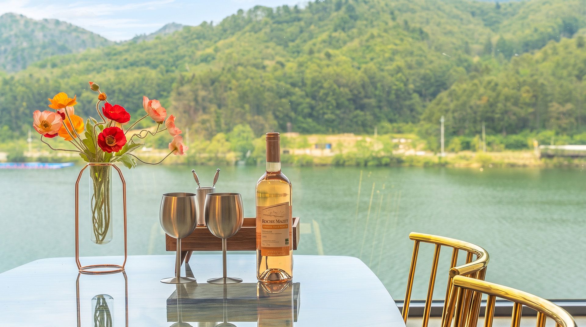 A table with a bottle of wine, two glasses, and a vase with flowers.