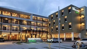 A multi-story hotel with a prominent "Grand Papua" sign.