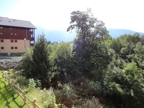 A building with a stone wall and a wooden fence.