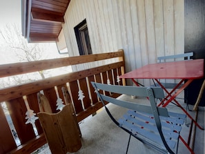 Enjoy the simple, functional balcony with a bench and table.