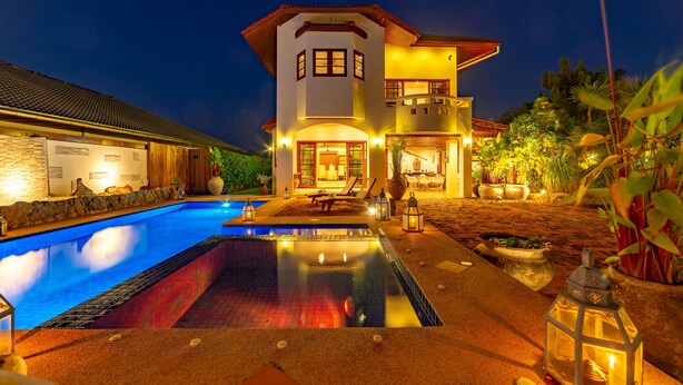 A two-story house with a swimming pool and outdoor seating area. - Tropical 6 Bedroom Villa Sanctuary (Hua Hin)