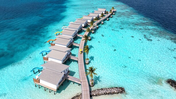 An overwater bungalow resort with a long pier connecting the buildings to the shore. - Oaga Art Resort (Maaranfushi)