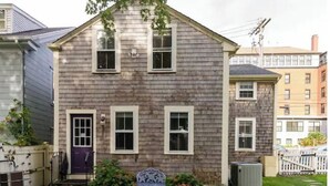 A two-story house with a front porch, a small garden, and a mailbox. - Located close to wedding venues, university, shops and eateries and Newport.   (Bristol)