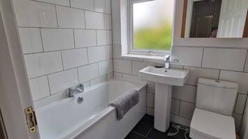 Combined shower/bathtub, hair dryer, towels, soap
