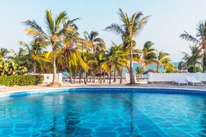 A clear blue pool surrounded by palm trees and white lounge chairs. - JUMBO CLUB WATAMU (Watamu)