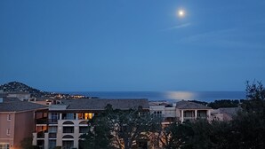 A coastal residential area with buildings and a view of the ocean.
