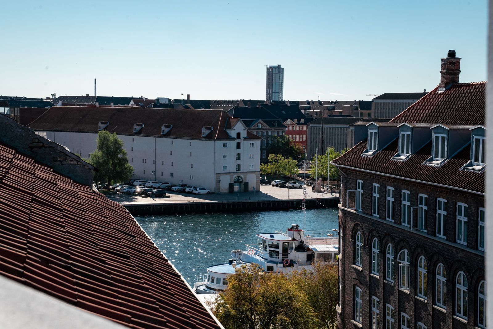 A river with boats, a bridge, and buildings with distinct architectural styles.