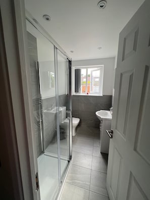 Shower, hair dryer, towels, toilet paper
