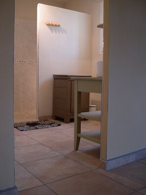 A bathroom with a toilet, sink, and cabinet.
