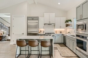 Enjoy cooking in this well-lit kitchen with a central island and stainless steel appliances.