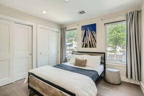 Relax in this serene bedroom with a large bed and a window offering a view of the outdoors.