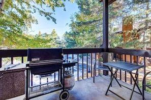A balcony with a Weber grill, a metal table, and a gas cylinder. - Red Pine Condos by Park City Vacations (Park City)