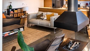 A modern living room with a sofa, coffee table, and a fireplace. - Countryside villa in the most magnificent views of Alentejo (Estremoz)