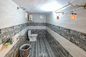 A bathroom with a toilet, a bidet, a sink, and a shower. - NK Desert Camp & Resort (Jaisalmer)