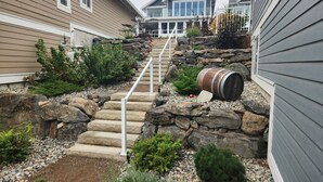 A residential property with a stone staircase, a barrel, and a well-maintained garden. - Tempranillo Suite on Osoyoos Lake #269b (Osoyoos)