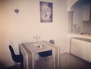 A dining area with a table, chairs, and a candelabra. - Spa house with private Jacuzzi and whirlpool bath overlooking the countryside (Saint-Genest-Lerpt)