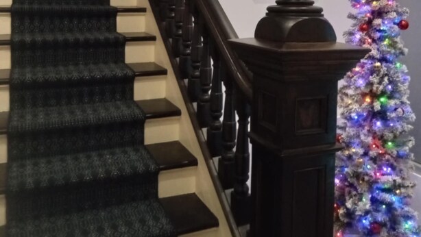 A staircase with a dark wooden handrail and a patterned carpet. - Sandwich Boutique Hotel (Windsor)
