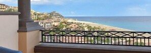 A balcony with a view of a beach and buildings. - Pueblo Bonito II (Cabo San Lucas)
