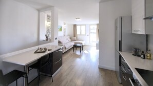 Een moderne keuken met een eethoek, een bank en een groot raam.