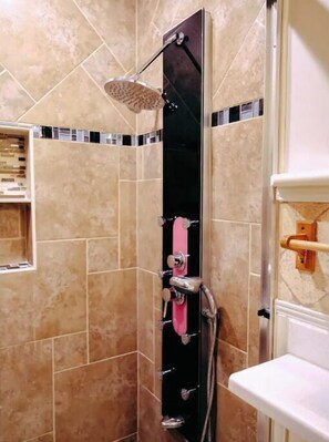 A shower with a handheld showerhead and a wall-mounted faucet. - Picture Perfect Paradise 3br / 3ba (Orange Park)