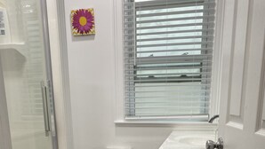 A small bathroom with a shower, toilet, and sink. - Cozy Private Share Room (Englewood)