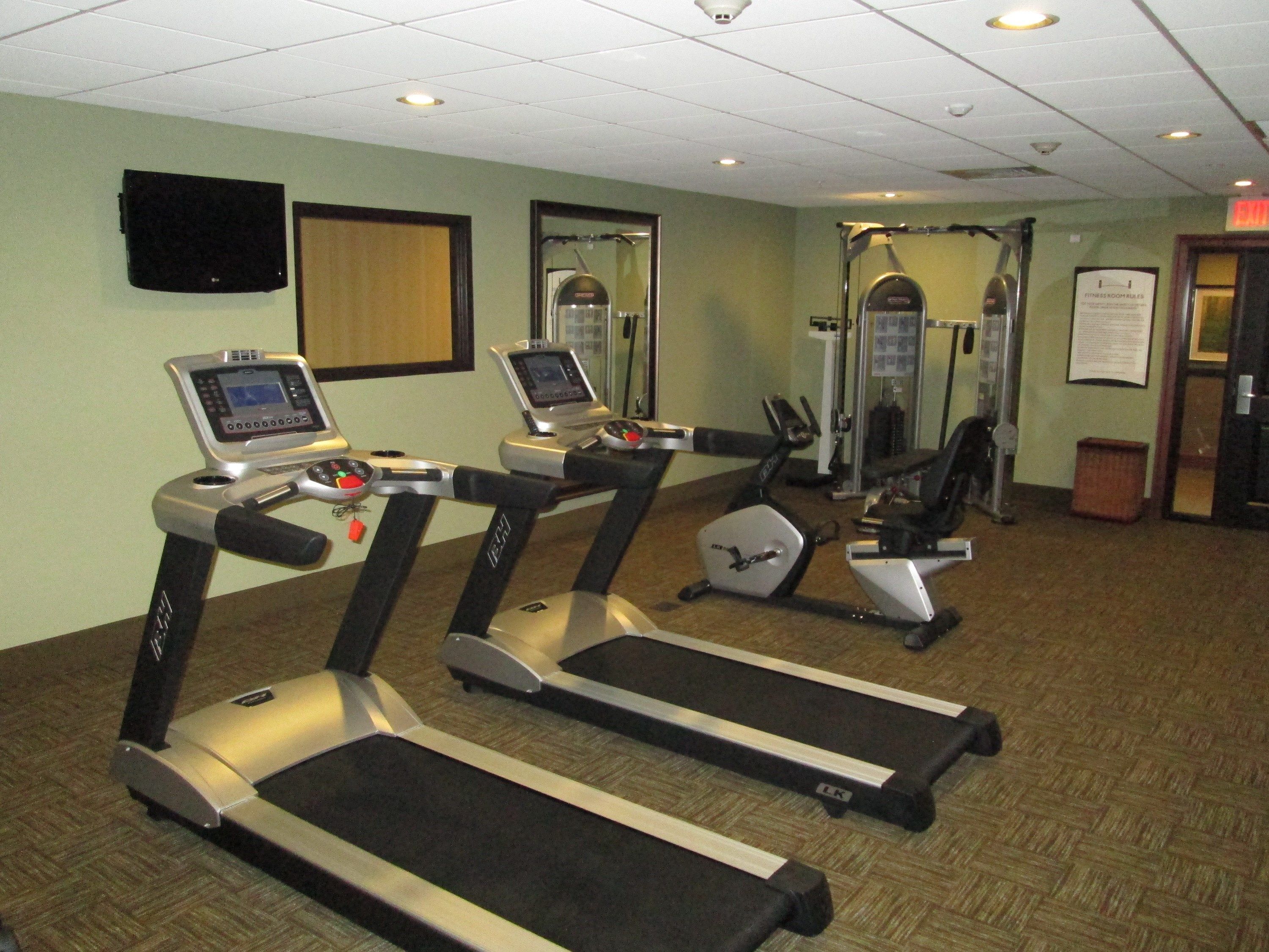 A gym with treadmills, a stationary bike, and a weight machine.