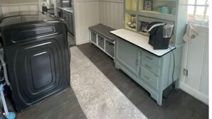 A kitchen with a built-in coffee station, a bench, and a view of the dining area. -  Cape Cod cottage close to Prembroke Creek (Edenton)