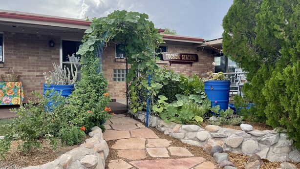 A garden entrance with a stone pathway leading to a building labeled 'Tucson Station'. - Quiet Eco-Friendly Home Close to Downtown & Desert—Wildlife in Abundance! (Tucson)