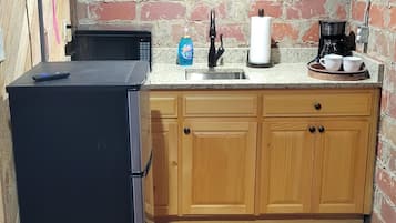 Fridge, microwave, coffee/tea maker, cookware/dishes/utensils