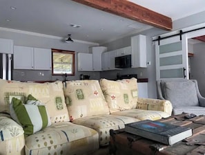 Relax in this cozy living area with a sofa, coffee table, and armchair.