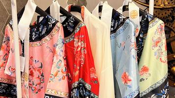 A rack of colorful scarves with intricate floral patterns.
