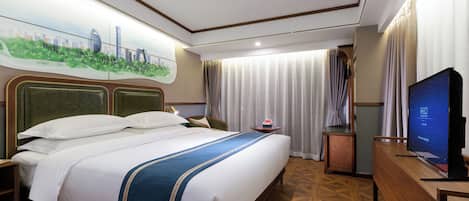 A hotel room with a large bed, a television, a wooden dresser, and a painting of a cityscape on the wall.