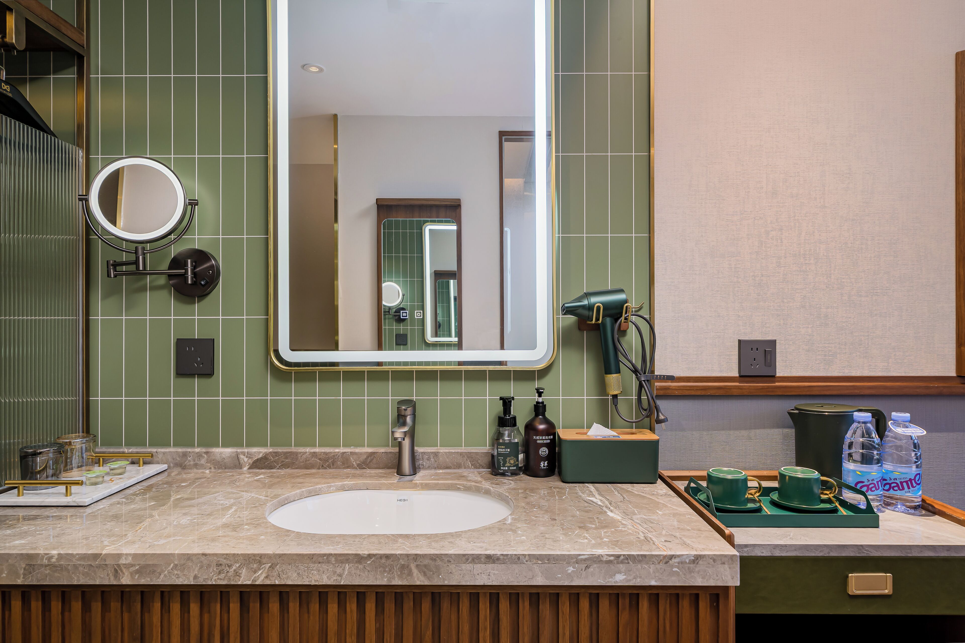 A bathroom with a sink, mirror, and toiletries.