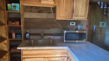 Fridge, microwave, coffee/tea maker, cookware/dishes/utensils