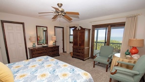 A bedroom with a bed, a dresser, a chair, a table, a ceiling fan, and a view of the ocean. - OCEANFRONT, 4 BRs, Ocean Views, NP13-2, Summer Wind (Duck)