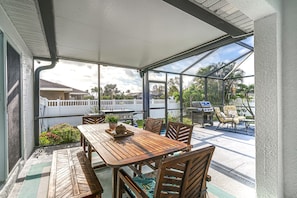 Enjoy al fresco dining and socializing in this outdoor space with a grill and comfortable seating.