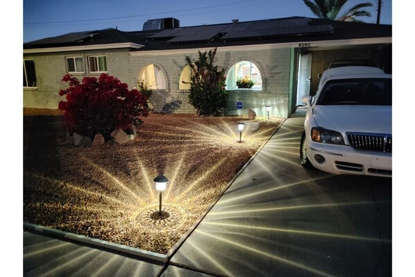 Stroll through the garden and enter this charming home with a driveway and arched windows.