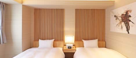A hotel room with two beds, wooden paneling, a painting on the wall, and a nightstand with a lamp.