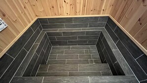 A set of dark grey tiled stairs with wooden paneling on the walls. - shirahamakashibesso ss2-43 (Shirahama)