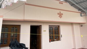 A building with a flat roof, a door, and windows.