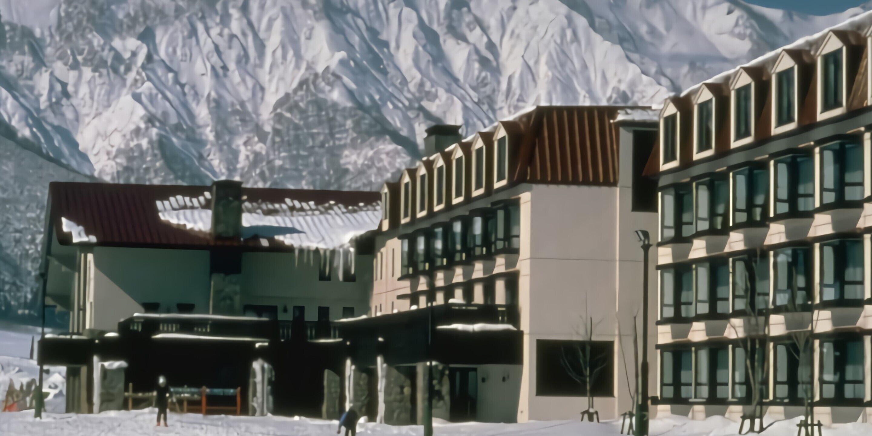 A modern building with a mix of architectural styles, including a section with a sloped roof and another with a flat facade.