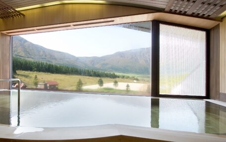 A spa area with a large window offering a view of a mountainous landscape.