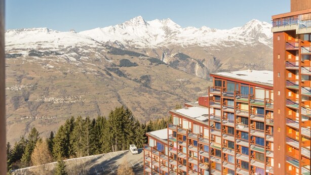 A hotel with a view of snow-capped mountains.