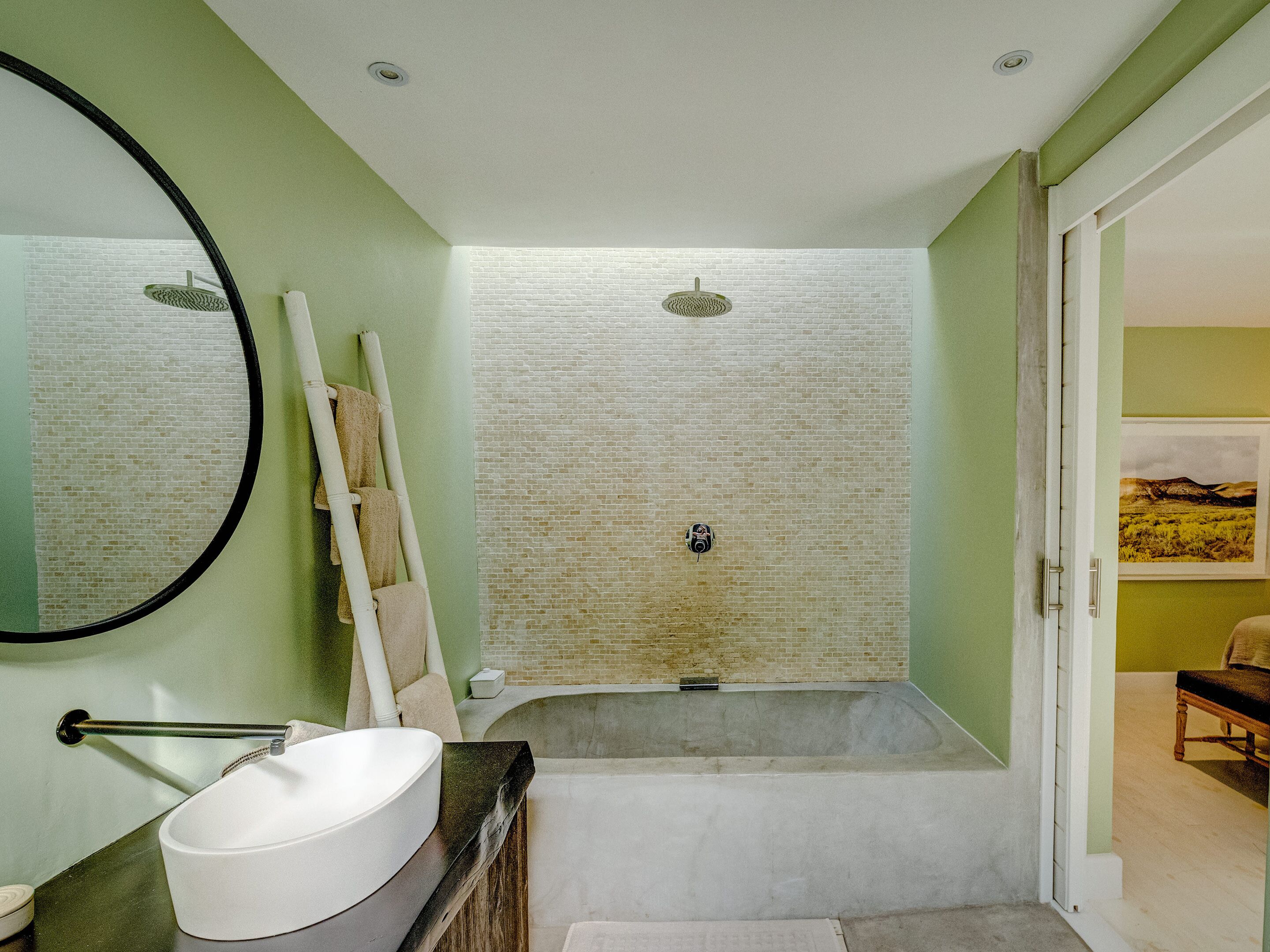 Une salle de bain avec une baignoire, un lavabo et un miroir.