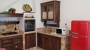 A kitchen with a gas stove, oven, microwave, and a red refrigerator. - Appartamento Nuovo A Chioggia Vista Laguna (Chioggia)