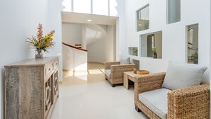A modern interior with wicker furniture, a staircase, and a minimalist design. - Villa Las Arenas with private heated pool (Salobreña)