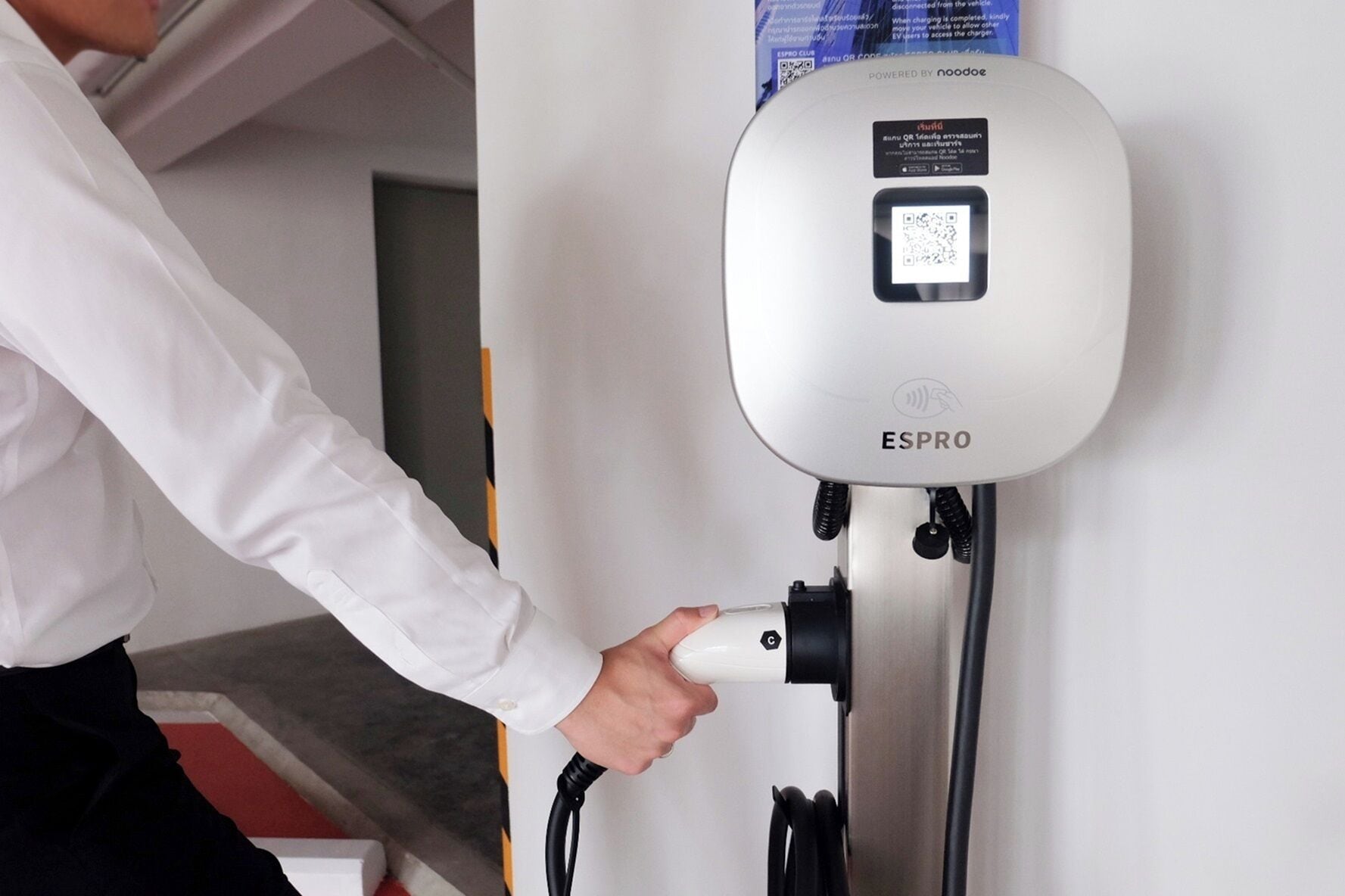 A person using an ESPRO electric vehicle charging station.