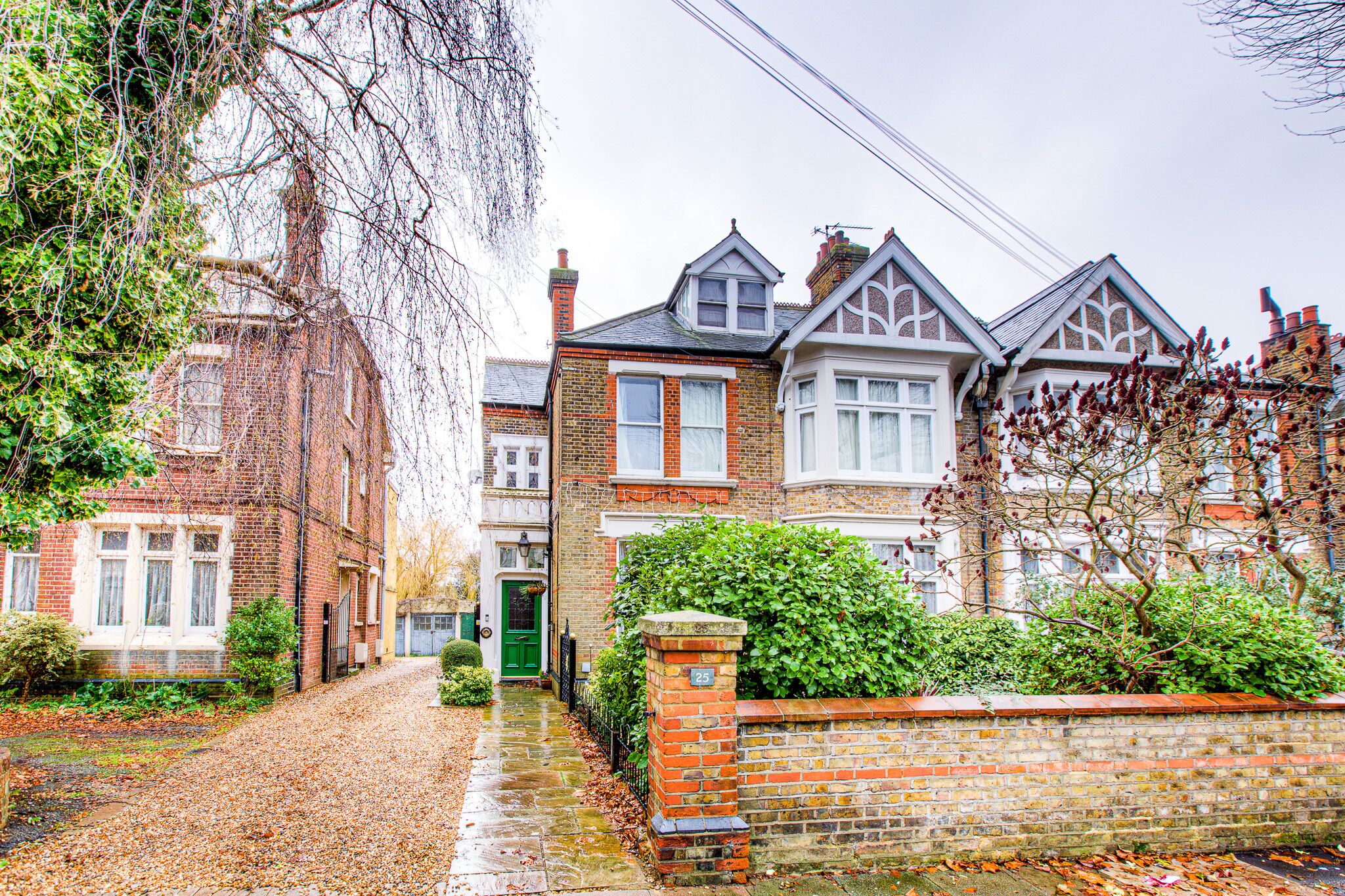 A traditional brick house with a green door, a brick wall, and a small garden. - Entire Artistic Open-plan Top Floor Apartment (Westcliff-on-Sea)