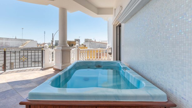 A rooftop swimming pool with a view of the cityscape. - 2448 Palazzo Montagna - Suite by Barbarhouse (Melissano)