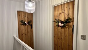 A wooden door with a mirror and a light fixture above it. - Penderyn Cottage, Waterfall Country, Brecon Beacons (Aberdare)